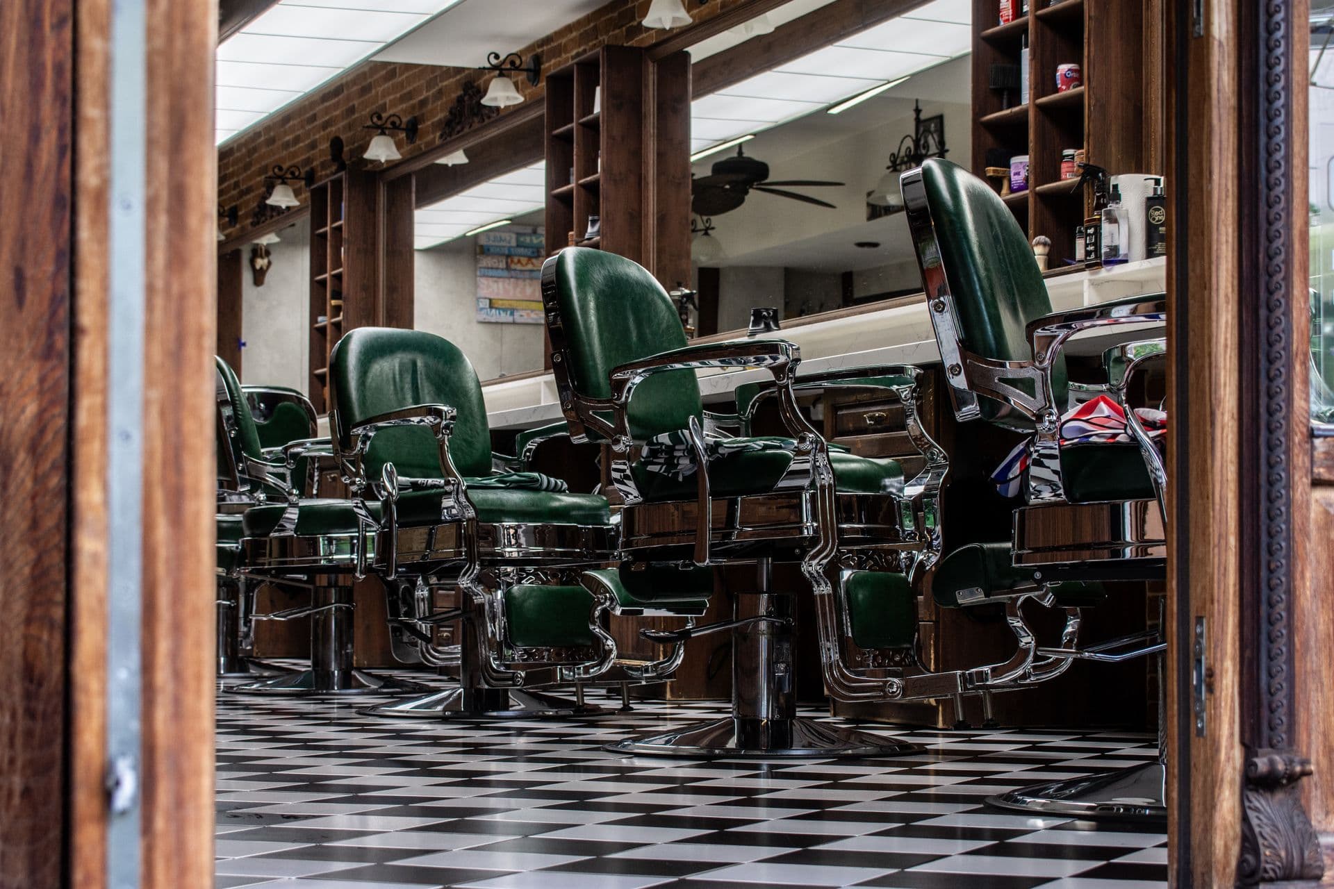 The interior of Tha Cut Barbershop in warm low light